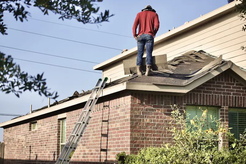 Professional roofer working on a residential roof in Farr West